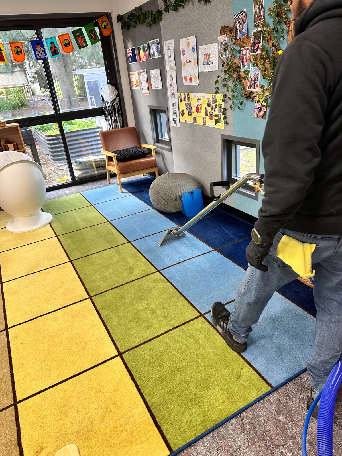 Carpet extraction underway in a colourful early learning centre play area