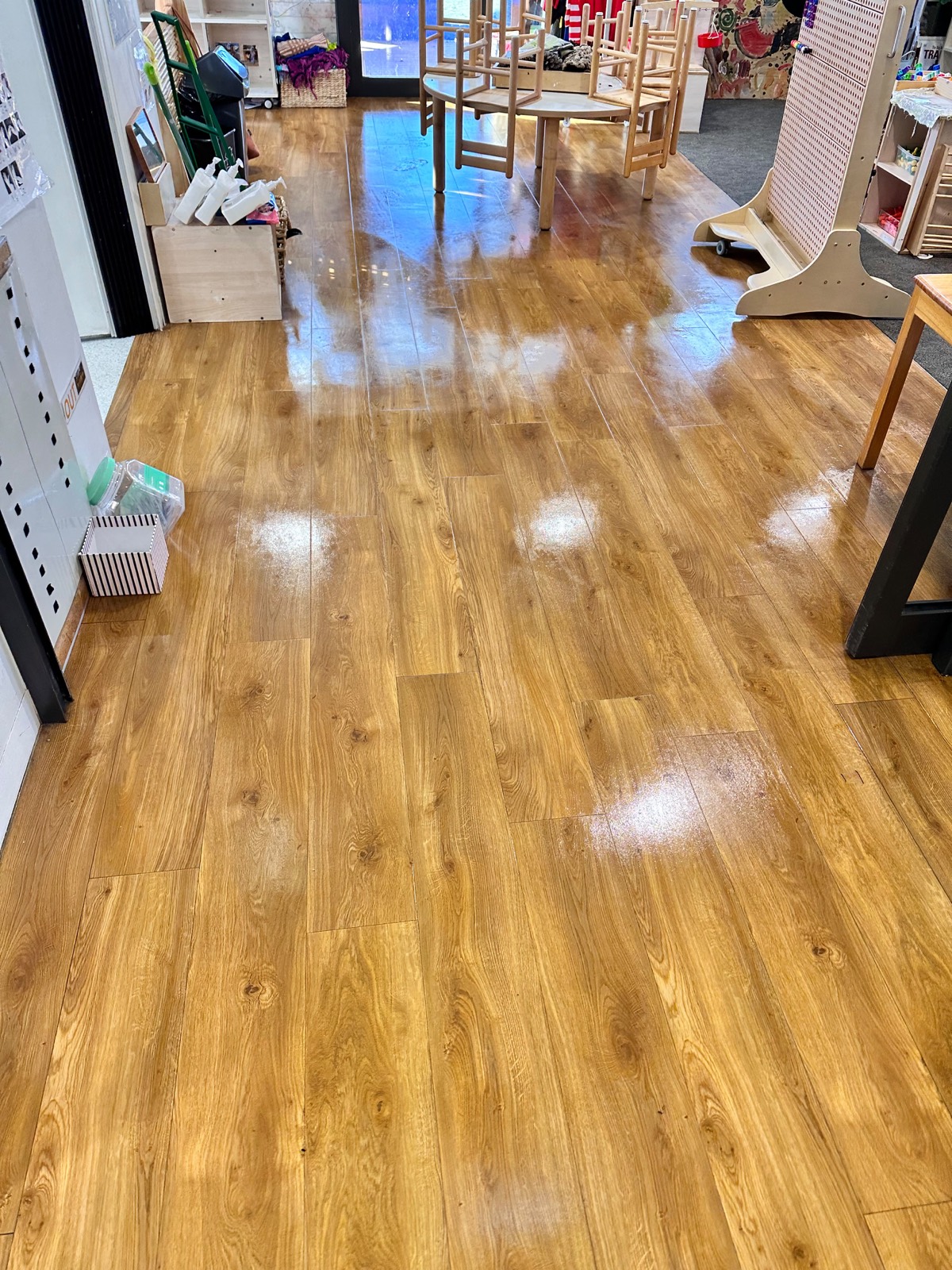 Timber-look hard floor in a kindergarten classroom stripped and resealed to a high-gloss finish